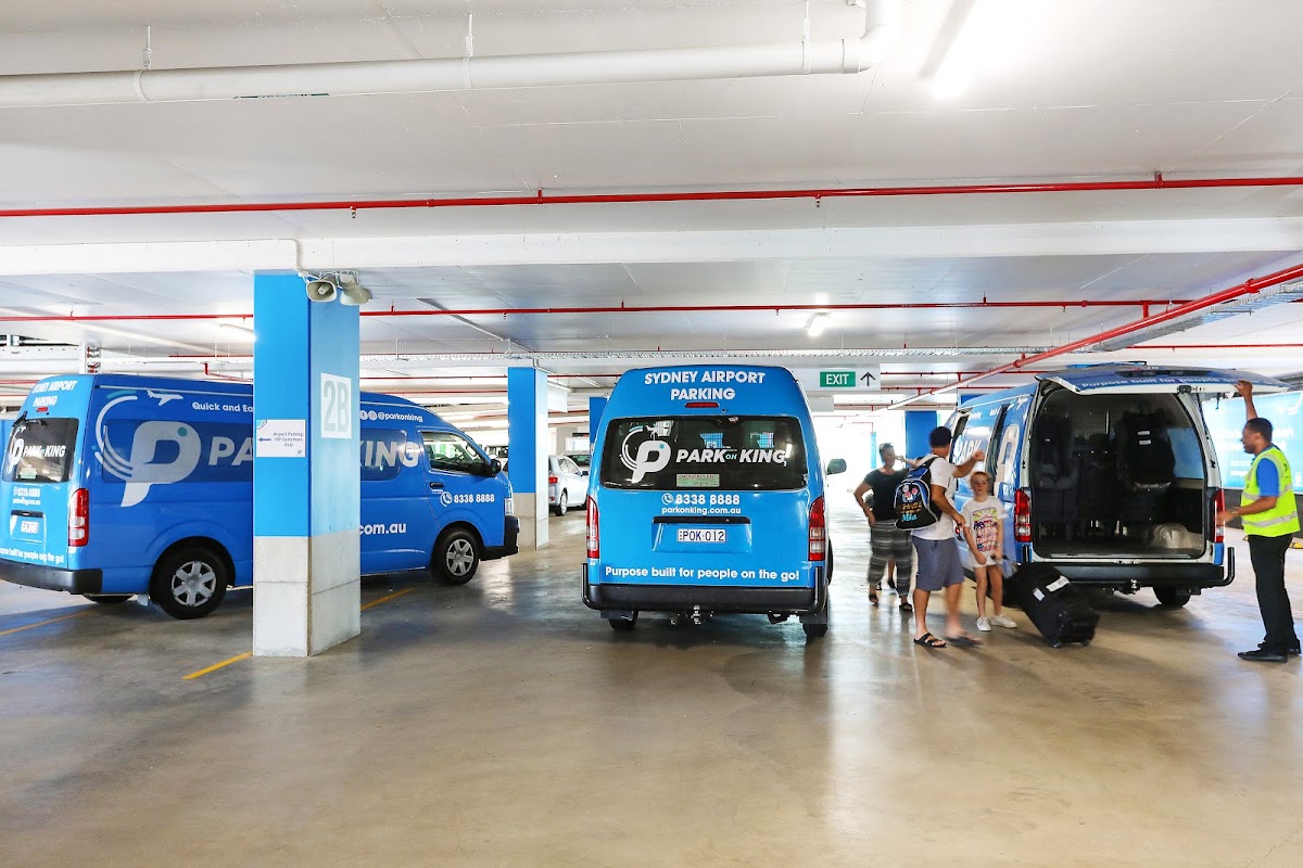 Indoor Park on King shuttle pickup area with passengers and luggage